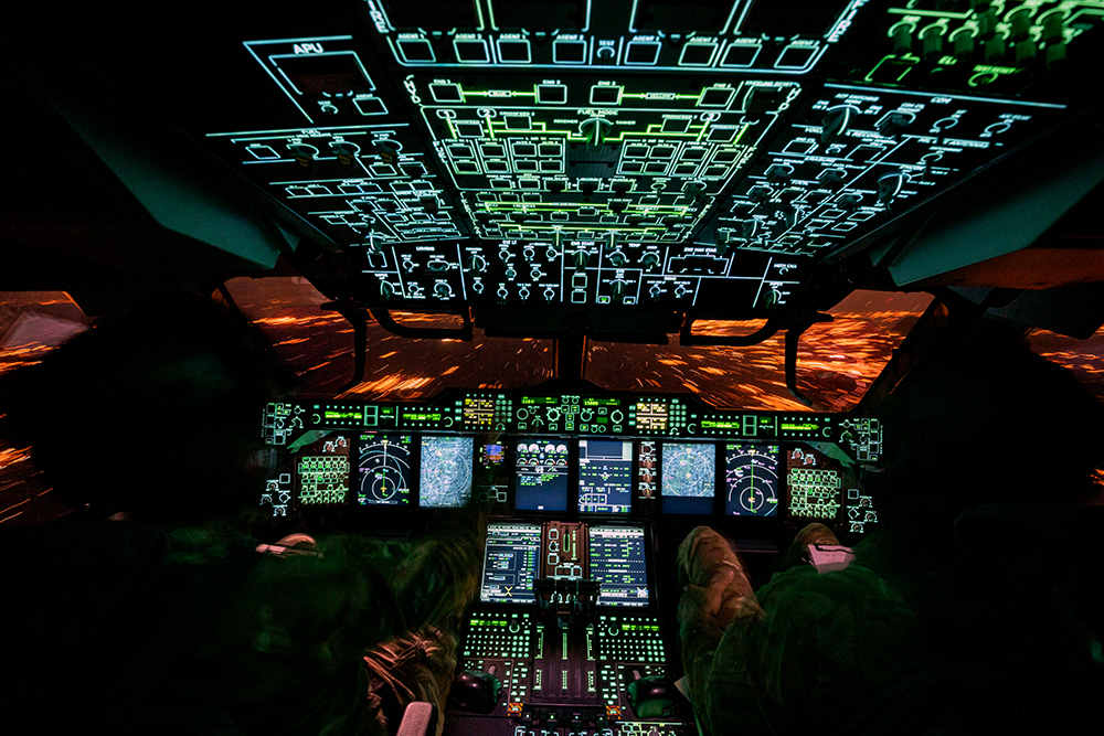 Photo: The Atlas flight deck, shown during a nightflight with control panels and glass screen instruments illuminated - pilot and co-pilot are in their respective seats